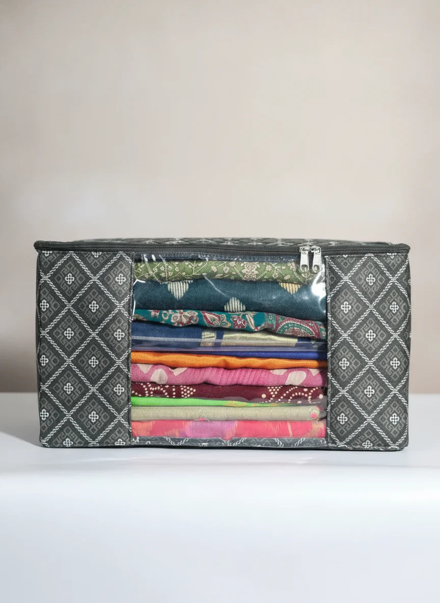 A rectangular fabric storage organizer with a clear front window showing neatly folded colorful garments inside, set against a plain light background.